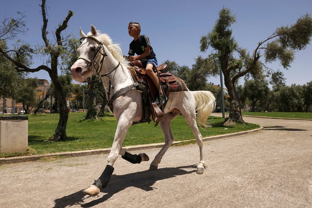 Palestinian youths take horse rides at a park in east Jerusalem as they celebrate the second day of the Muslim holiday of Eid al-Adha or the Feast of Sacrifice, on June 17, 2024. (Photo by Hazem Bader/AFP Photo)