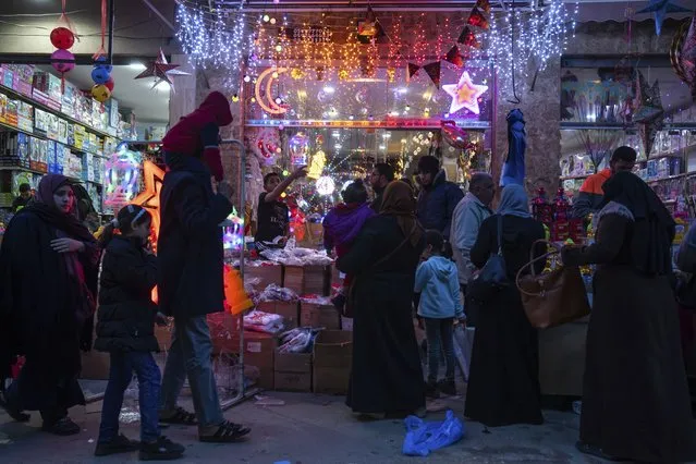 Palestinians shop for festive lights and other decorations in the Zawiya market ahead of the Muslim holy month of Ramadan, in Gaza City, Tuesday, March 21, 2023. (Photo by Fatima Shbair/AP Photo)