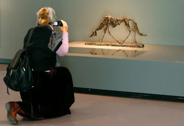 A woman takes a picture of the sculpture “The Dog” during a media preview of the exhibition “Alberto Giacometti – Material and Vision” of late Swiss artist Alberto Giacometti at the Kunsthaus Zurich art museum in Zurich, Switzerland October 27, 2016. (Photo by Arnd Wiegmann/Reuters)
