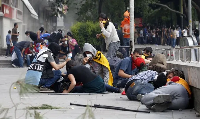 Demonstrators take cover as Turkish riot police use tear gas to disperse them during a protest against Turkey's Prime Minister Tayyip Erdogan and his ruling AK Party in central Ankara June 2, 2013. (Photo by Umit Bektas/Reuters)