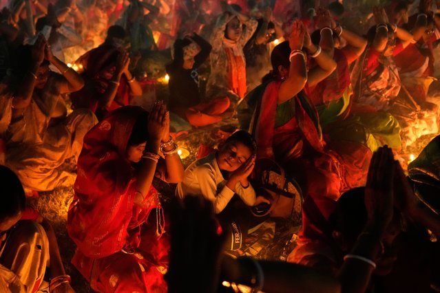 Devotees pray Rakher Upobash ritual, a religious festival honoring Hindu saint Loknath Brahmachari, at a temple in Chakla, India, November 15, 2025. (Photo by Bikas Das/AP Photo)