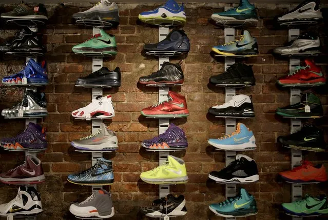 In this January 12, 2015 photo, a wall of collectable sneakers are displayed at Sneaker Pawn in the Harlem section of New York. Basketball sneakers can re-sell for hundreds of dollars, depending on the model, the size of the production run and how easy it is to find a pair in good condition. (Photo by Seth Wenig/AP Photo)