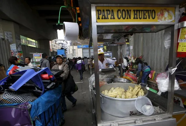 Street vendors push their carts near a Metro train station in downtown Lima, Peru December 1, 2015. (Photo by Mariana Bazo/Reuters)
