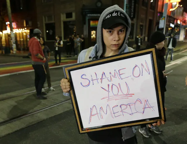 Felomina Cervantes, of Seattle, holds a sign that reads “Shame on You America” as she takes part in a protest against President-elect Donald Trump, Wednesday, November 9, 2016, in Seattle's Capitol Hill neighborhood. (Photo by Ted S. Warren/AP Photo)