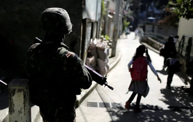 A Brazilian navy soldier patrols the area at Chapeu Mangueira slum in Rio de Janeiro, Brazil June 21, 2018. (Photo by Bruno Kelly/Reuters)