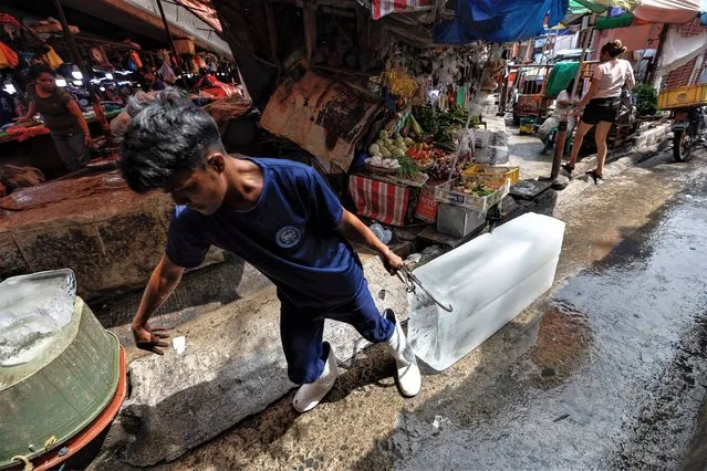 A vendor pulls a block of ice at a market in Quezon City, Metro Manila, Philippines on June 7, 2023. Data from the Philippine Statistics Authority released on 06 June showed that the country's overall inflation fell to 6.1 percent in May 2023 from 6.6 percent in April 2023. Main factors in the deceleration were lower prices and costs in transport, food and non-alcoholic beverages, the Philippine Statistics Authority said. (Photo by Rolex dela Peña/EPA/EFE)
