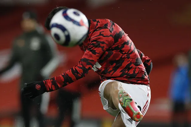 Manchester United's Bruno Fernandes warms up before an English Premier League soccer match between Manchester United and Newcastle at the Old Trafford stadium in Manchester, England, Sunday February 21, 2021. (Photo by Phil Noble/Pool via AP Photo)