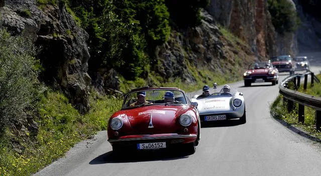 Participants drive their cars up Mount Stoderzinken during the Ennstal Classic rally near the small Austrian village of Groebming, on July 18, 2013. Some 206 classic cars took part in a three day vintage and classic car rally around Ennstal. (Photo by Leonhard Foeger/Associated Press)