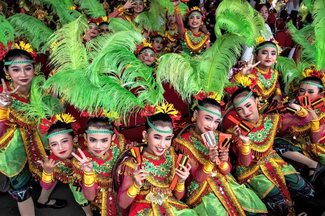 Dancers pose for photographs during the Surabaya Cross Culture International Folk Art Festival (SCCIFAF) in Surabaya on July 16, 2023. (Photo by Juni Kriswanto/AFP Photo)