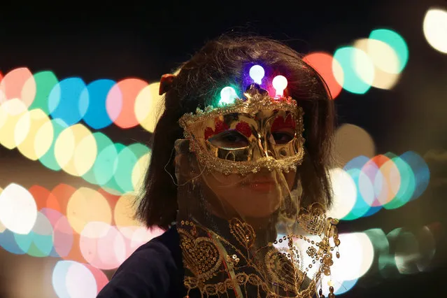 A girl wearing a mask takes part in a procession celebrating the religious holiday of Mawlid al-Nabi, the birthday of Prophet Mohammad, in Benghazi, Libya December 10, 2016. (Photo by Esam Omran Al-Fetori/Reuters)