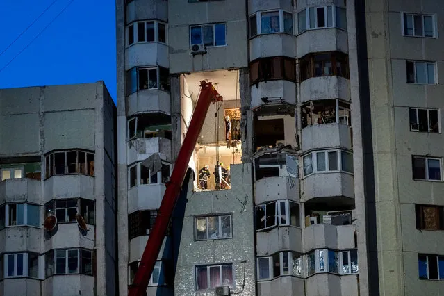 Firemen and engineers continue a rescue operation, inspecting and searching for missing people at the scene of a blast in a 21-storey apartment block in Chisinau, Moldova, 07 October 2018. According to police reports, three people died and ten people were hospitalized after a natural gas cylinder exploded in the house on night of 06 October 2108. Due to instability of the building, engineers are trying to stabilize the building to aid the extraction of victims. (Photo by EPA/EFE/Stringer)