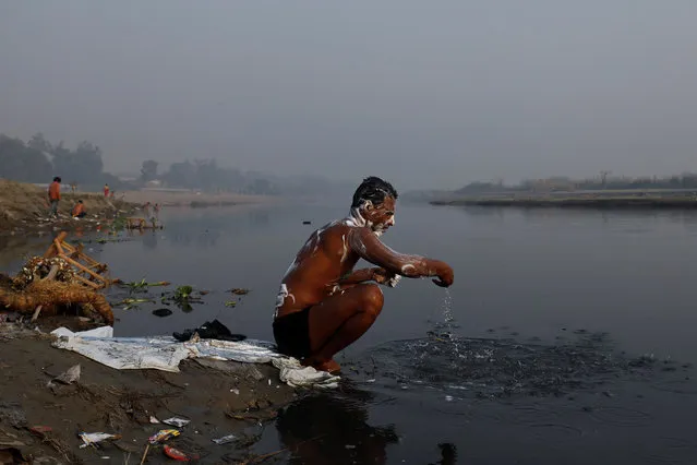 A man bathes in the polluted waters of the Yamuna river in New Delhi, India, October 25, 2018. (Photo by Anushree Fadnavis/Reuters)