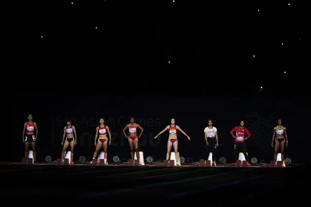 Runners prepare to compete during the women's 100-meter final at the 19th Asian Games in Hangzhou, China, Saturday, September 30, 2023. (Photo by Vincent Thian/AP Photo)