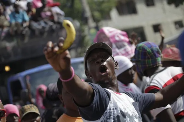 A supporter of presidential candidate Jovenel Moise chants as he holds a banana (Jovenel Moise is also known as “Neg bannan nan”, “Banana man”) during a demonstration to demand the speedy organization of a postponed presidential runoff election in Port-au-Prince, Haiti, January 28, 2016. Discussions are underway on how to move forward after Haiti's presidential election collapsed last week, said high-ranking officials on January 27, 2016. (Photo by Andres Martinez Casares/Reuters)