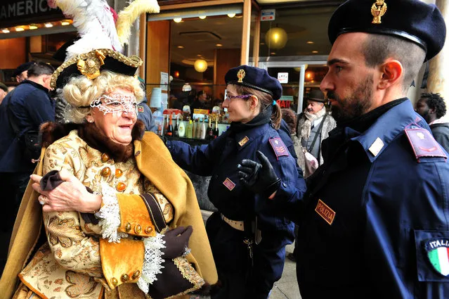 A masked woman goes through a security check in Venice, Italy, Sunday, January 30, 2016. (Photo by Luigi Costantini/AP Photo)