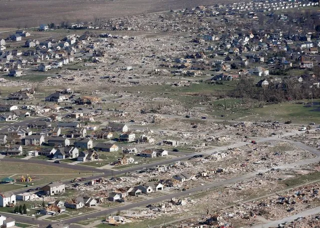 This aerial view on Monday, November 18, 2013, shows the path of a tornado that hit the western Illinois town of Washington on Sunday. It was one of the worst-hit areas after intense storms and tornadoes swept through Illinois. The National Weather Service says the tornado that hit Washington had a preliminary rating of EF-4, meaning wind speeds of 170 mph to 190 mph. (Photo by Charles Rex Arbogast/AP Photo)
