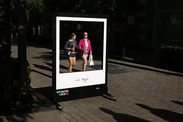 In this April 15, 2015, photo, people walk by the Polaroid Fotobar store at the Linq in Las Vegas. Whether you're coming to Las Vegas for a convention, wedding or just a vacation, casinos are just one option, along with shopping, spas, food, nightlife, festivals and various other adventures. (Photo by John Locher/AP Photo)