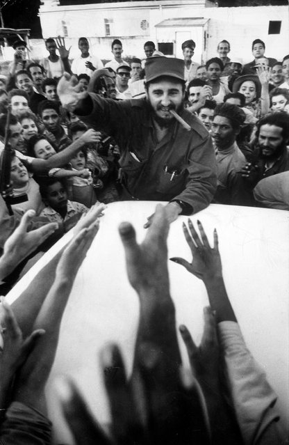 Rebel leader Fidel Castro (C) being cheered by a village crowd on his victorious march to Havana on January 01, 1959. (Photo by Grey Villet/The LIFE Picture Collection/Getty Images)
