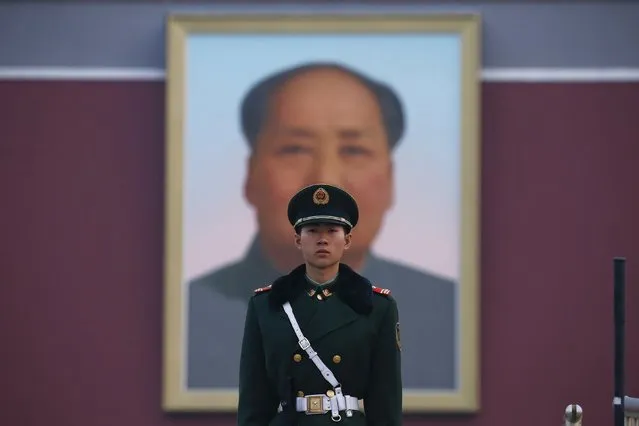 A paramilitary policeman stands guard in front of a portrait of late Chinese Chairman Mao Zedong at the Tiananmen Gate as the area near the Great Hall of the People is prepared for upcoming annual sessions of the National People's Congress (NPC) and Chinese People's Political Consultative Conference (CPPCC) in Beijing March 3, 2016. (Photo by Aly Song/Reuters)