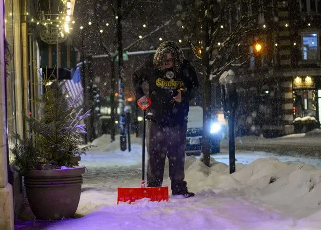 Jasmine Soneshine, a Brattleboro, Vt., resident, shovels a section of sidewalk on Main Street in Brattleboro as the snow falls on Tuesday, January 9, 2024. (Photo by Kristopher Radder/The Brattleboro Reformer via AP Photo)