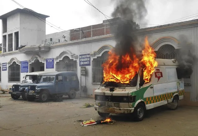 An ambulance goes up in flames after it was set fire by angry villagers at a government hospital in Siwan, about 200 kilometers (125 miles) north of Patna, Bihar state, India, Monday, April 20, 2015. Villagers who took injured students of a road accident to this hospital became incensed when they discovered no doctors were present. About 100 people attacked the hospital in anger and burned six vehicles, including this ambulance. (Photo by Abhinav Patel/AP Photo)