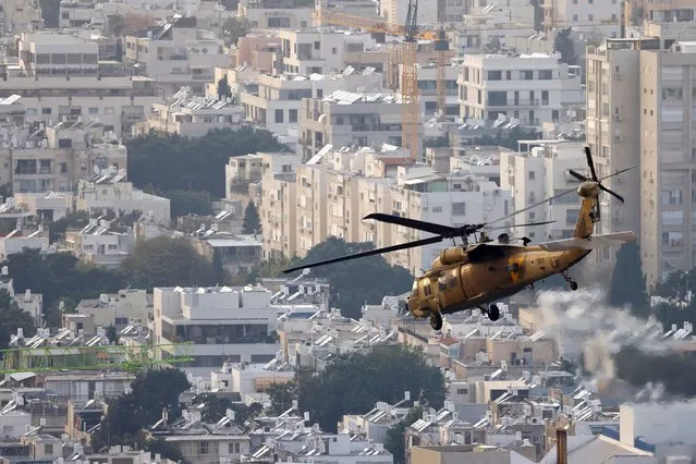 A military helicopter flies over Tel Aviv after lifting off from the Tel Aviv Sourasky Medical Center (Ichilov), amid the ongoing conflict between Israel and the Palestinian Islamist group Hamas, Israel on December 27, 2023. (Photo by Clodagh Kilcoyne/Reuters)