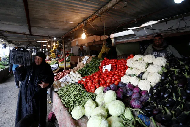 An Iraqi woman shops at a market in Qayyara, south of Mosul, Iraq, January 28, 2017. (Photo by Muhammad Hamed/Reuters)