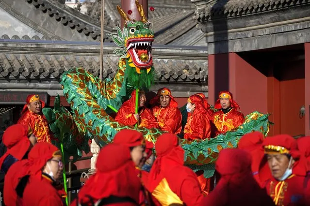 Chinese dragon dancers and performers dressed in traditional costumes wait to participate in a performance at the Dongyue Temple during the first day of the Chinese Lunar New Year in Beijing, Saturday, February 10, 2024. (Photo by Andy Wong/AP Photo)