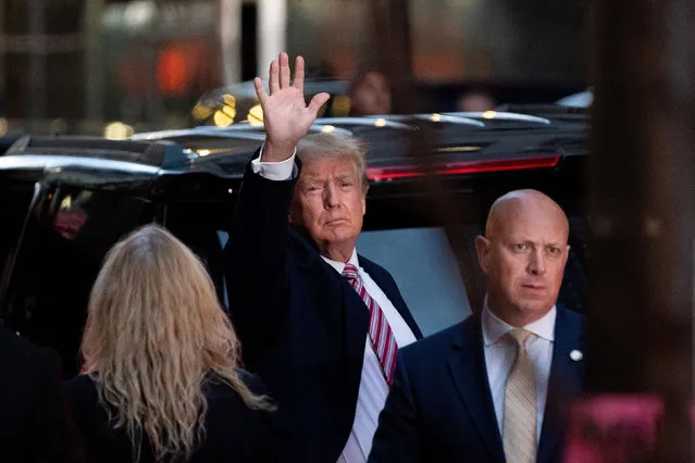 Former U.S. President Donald Trump acknowledges people as he gets in his SUV outside Trump Tower in the Manhattan borough of New York City, New York, U.S., October 18, 2021. (Photo by Jeenah Moon/Reuters)