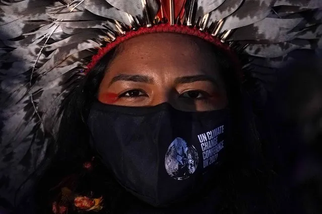 An Indigenous climate activist attends a rally at the end of a protest organized by the Cop26 Coalition in Glasgow, Scotland, Saturday, November 6, 2021 which is the host city of the COP26 U.N. Climate Summit. (Photo by Alberto Pezzali/AP Photo)