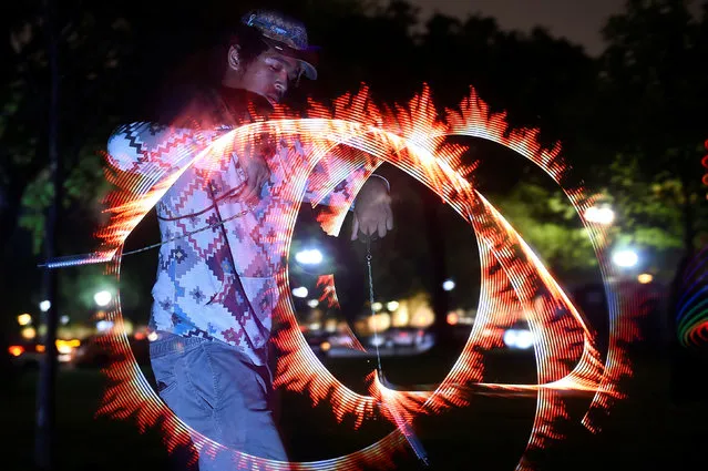 A man dances with light at an event event called “Catharsis on the Mall” in Washington, U.S., May 4, 2019. (Photo by Clodagh Kilcoyne/Reuters)