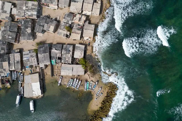 Aerial view of houses affected by sea level rise in Tierra Bomba Island, Cartagena, Colombia, taken on February 24, 2024. Every year the sea level rises and swallows the bay of Cartagena in dribs and drabs. A cemetery washed away by the waves shows the effects of global warming in Colombia's most touristic city, which could be partially underwater in this century. (Photo by Luis Acosta/AFP Photo)