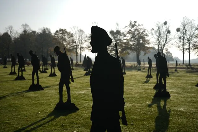 A new outdoor remembrance display, including 25 newly commissioned near-life-sized silhouettes of Indian soldiers from World War I stood alongside 100 British “Tommy” soldiers, is displayed at Hampton Court Palace, in south west London, Wednesday, November 3, 2021. The display created as part of the “Standing with Giants” project is to represent almost 1800 Indian soldiers who sailed to Britain in 1919 to take part in the World War I peace parade in London and were encamped on the grounds of Hampton Court for the duration of their stay. (Photo by Matt Dunham/AP Photo)