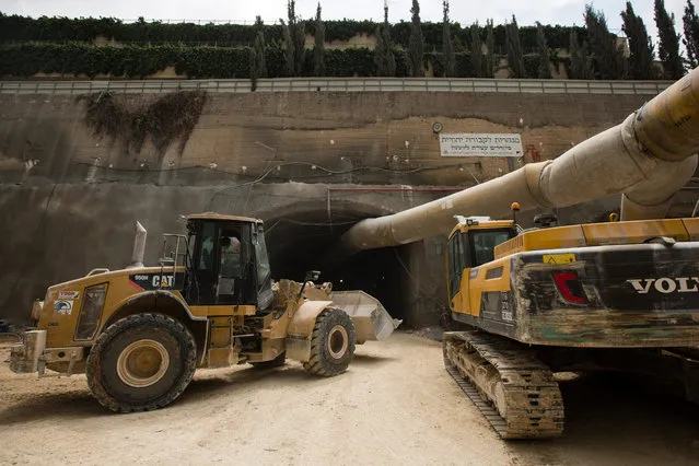 Construction machinery and vehicles are seen at the entrance to the construction site of an underground tunnel designated for traditional Jewish burial at the Givat Shaul cemetery, on May 14, 2015, in Jerusalem, Israel. (Photo by David Vaaknin/The Washington Post)