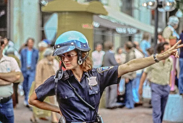 A female motorcycle cop directs traffic wearing crash helmet, Haywarket Square, Boston, Massachusetts, 1979. (Photo by Spencer Grant/Getty Images)