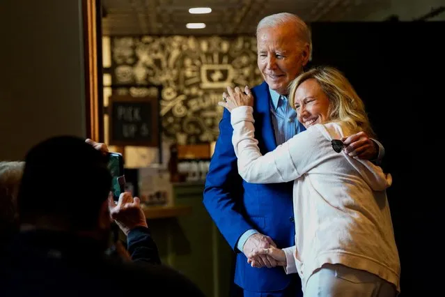 U.S. President Joe Biden embraces a customer as he visits Zummo's Cafe in Scranton, Pennsylvania on April 17, 2024. (Photo by Elizabeth Frantz/Reuters)