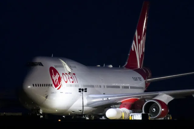A general view of Cosmic Girl, a Boeing 747-400 aircraft carrying the LauncherOne rocket under its left wing, as final preparations are made at Cornwall Airport Newquay on January 9, 2023 in Newquay, United Kingdom. Virgin Orbit launches its LauncherOne rocket from the spaceport in Cornwall, marking the first ever orbital launch from the UK. The mission has been named Start Me Up after the Rolling Stones hit. The plane released the rocket, carrying nine small satellites for a mix of civilian and domestic uses. But about two hours after the plane took off, the company reported “an anomaly that has prevented us from reaching orbit”. (Photo by Matthew Horwood/Getty Images)