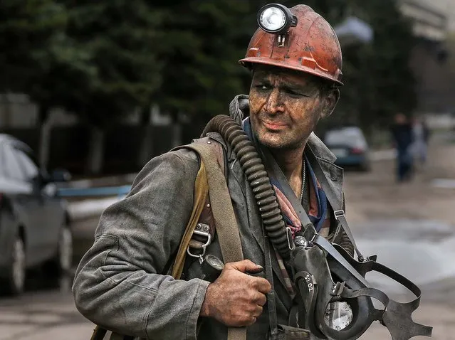 A rescue worker leaves the Skochinsky mine in Donetsk, Ukraine, on April 11, 2014. Seven coal miners were killed in the gas explosion at the coal mine. Seventy-eight people were working in the mine when the blast occurred after a sudden release of gas during work in the drilling pits. (Photo by Andrey Basevich/Associated Press)