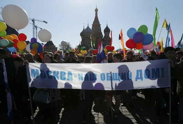 People hold a banner which reads “Moscow is our common home” during a May Day rally at Red Square in Moscow, Russia, May 1, 2016. (Photo by Maxim Zmeyev/Reuters)
