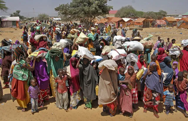 Somalis displaced by the drought, arrive at makeshift camps in the Tabelaha area on the outskirts of Mogadishu, Somalia Thursday, March 30, 2017. Somalia's current drought is threatening half of the country's population, or about 6 million people, and is joined by similar hunger crises in South Sudan, northeastern Nigeria and Yemen, which together make up what the United Nations calls the world's largest humanitarian disaster in more than 70 years. (Photo by Farah Abdi Warsameh/AP Photo)