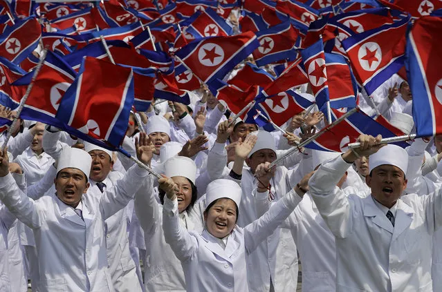 North Korean men and women dressed to represent doctors and other medical workers march across Kim Il Sung Square during a military parade on Saturday, April 15, 2017, in Pyongyang, North Korea to celebrate the 105th birth anniversary of Kim Il Sung, the country's late founder and grandfather of current ruler Kim Jong Un. (Photo by Wong Maye-E/AP Photo)