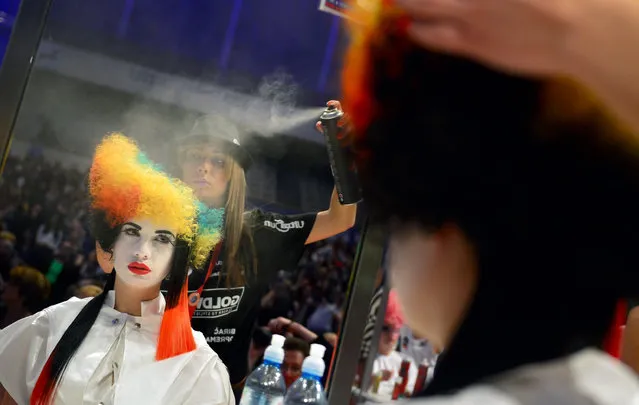 A hairdresser styles her model during the contest “Full Fashion Look” at the OMC Hairworld World Cup on May 4, 2014 in Frankfurt am Main, Germany. (Photo by Thomas Lohnes/Getty Images)