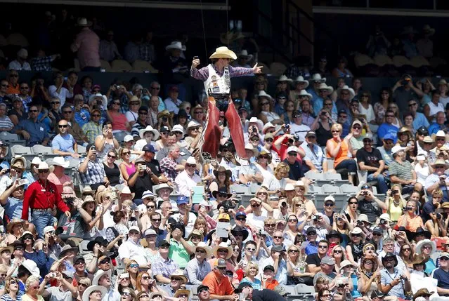 Bareback rider Tim O'Connell of Zwingle, Iowa flies into the arena on a wire before the start of the Calgary Stampede rodeo in Calgary, Alberta, July 10, 2015. (Photo by Todd Korol/Reuters)