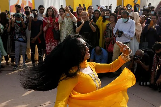 A member of the transgender community dances, while others clap as they participate in “Aurat March” or “Women's March”, to mark the International Women's Day in Karachi, Pakistan, March 8, 2022. (Photo by Akhtar Soomro/Reuters)
