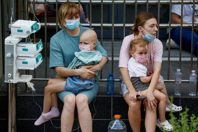 Women hold patients at Ohmatdyt Children's Hospital that was damaged during Russian missile strikes, amid Russia's attack on Ukraine, in Kyiv, Ukraine on July 8, 2024. (Photo by Gleb Garanich/Reuters)