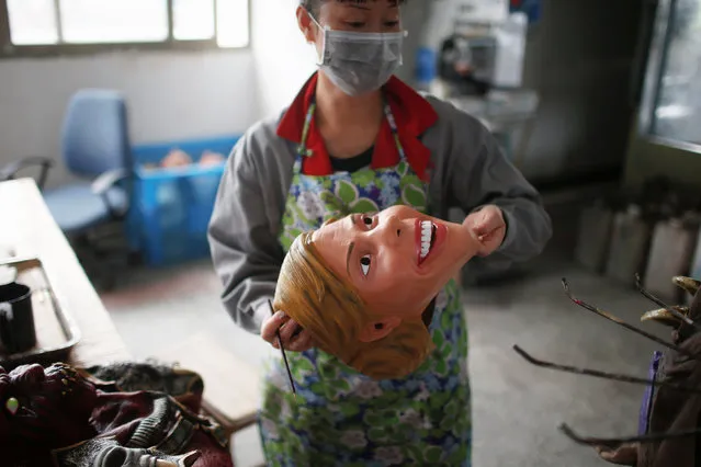 A worker checks a mask of U.S. Democratic presidential candidate Hillary Clinton, which she just painted, at Jinhua Partytime Latex Art and Crafts Factory in Jinhua, Zhejiang Province, China, May 25, 2016. (Photo by Aly Song/Reuters)
