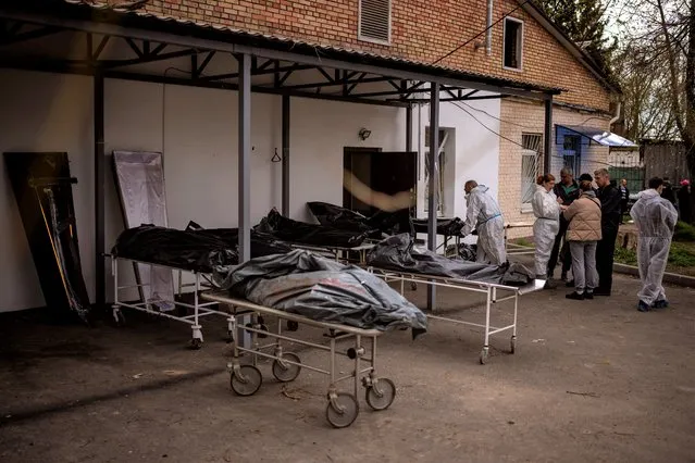 Dead bodies wait to be identified outside a morgue in Bucha, on the outskirts of Kyiv, Monday, April 25, 2022. (Photo by Emilio Morenatti/AP Photo)