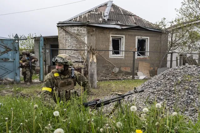 Ukrainian National Guard patrol during a reconnaissance mission in a recently retaken village on the outskirts of Kharkiv, east Ukraine, Saturday, May 14, 2022. (Photo by Bernat Armangue/AP Photo)