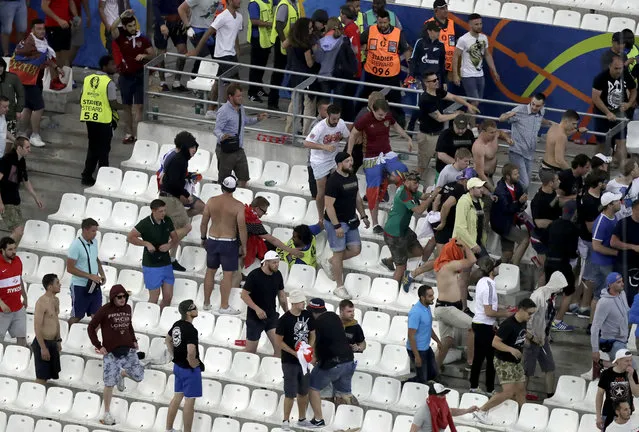 Supporters and stewards clash in the stands after the Euro 2016 Group B soccer match between England and Russia at the Velodrome stadium in Marseille, France, Saturday, June 11, 2016. (Photo by Ariel Schalit/AP Photo)
