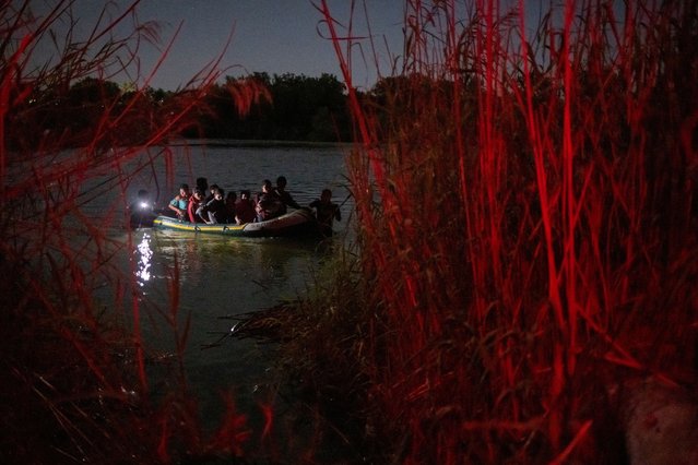 Smugglers pull a raft with asylum seeking migrants from Central and South America across the Rio Grande river into the United States from Mexico in Roma, Texas, U.S., May 14, 2022. (Photo by Adrees Latif/Reuters)